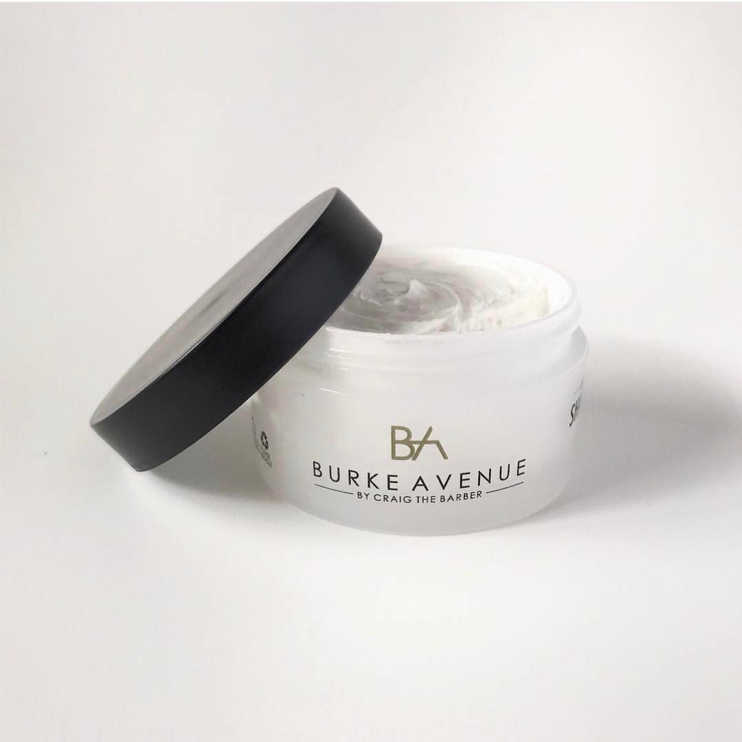 Burke Avenue Moisturizing Shave Cream by Craig the Barber shown in open jar with whipped cream texture on clean white background.