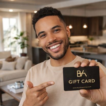 Man holding a gift card with 'BA' -Burke Avenue branding in a living room setting