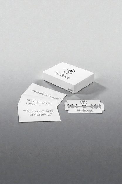 My-Blades razor blade box displayed with motivational quote cards and a single branded double-edge blade on a modern gray surface.